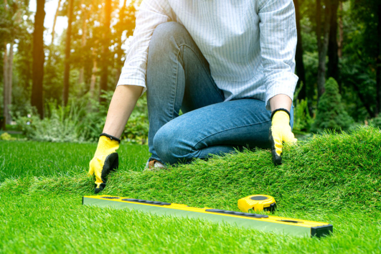 a person measuring turf